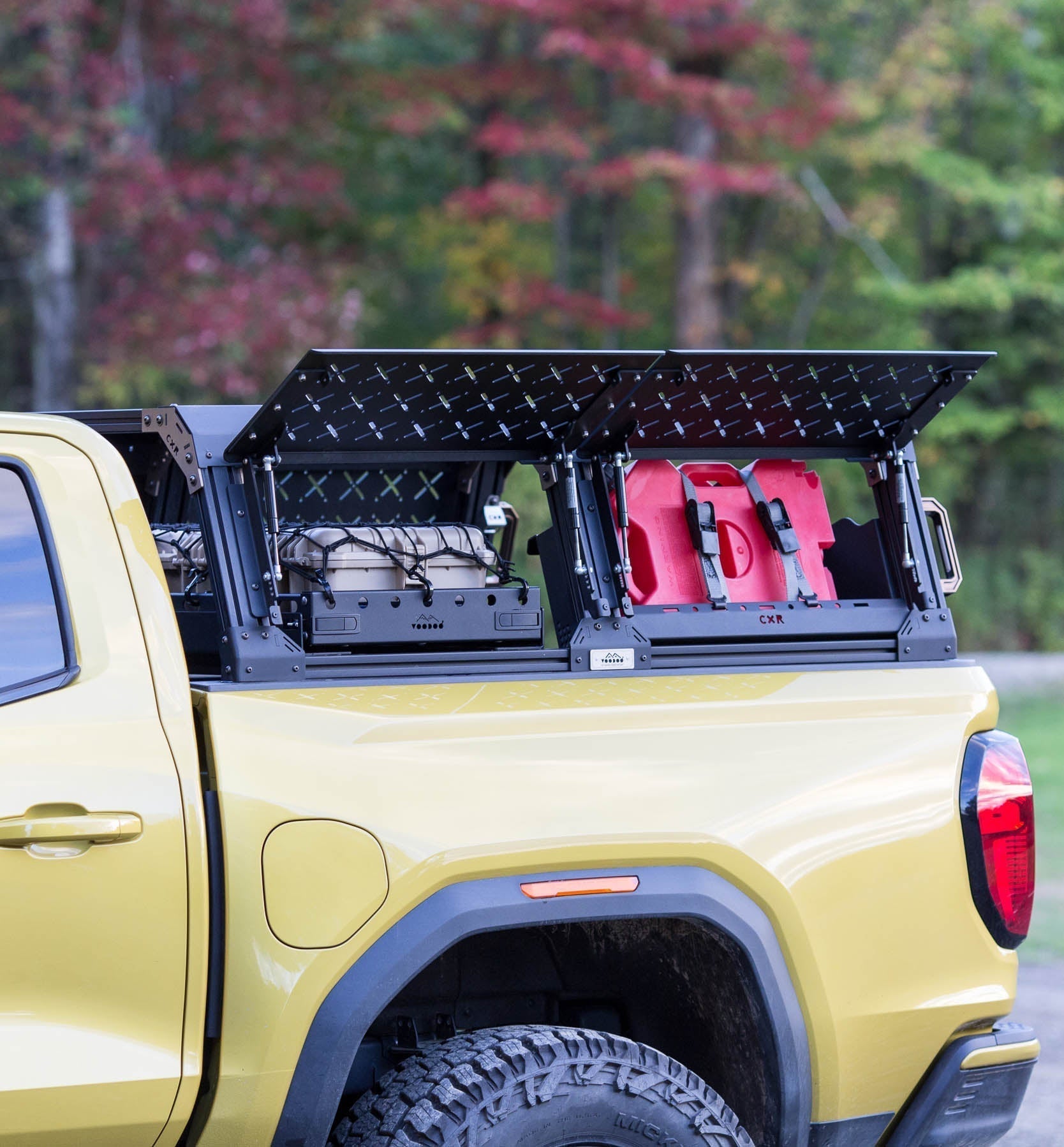KB Voodoo CXR Fortress overland bed rack with cargo access door open on yellow GMC Canyon
