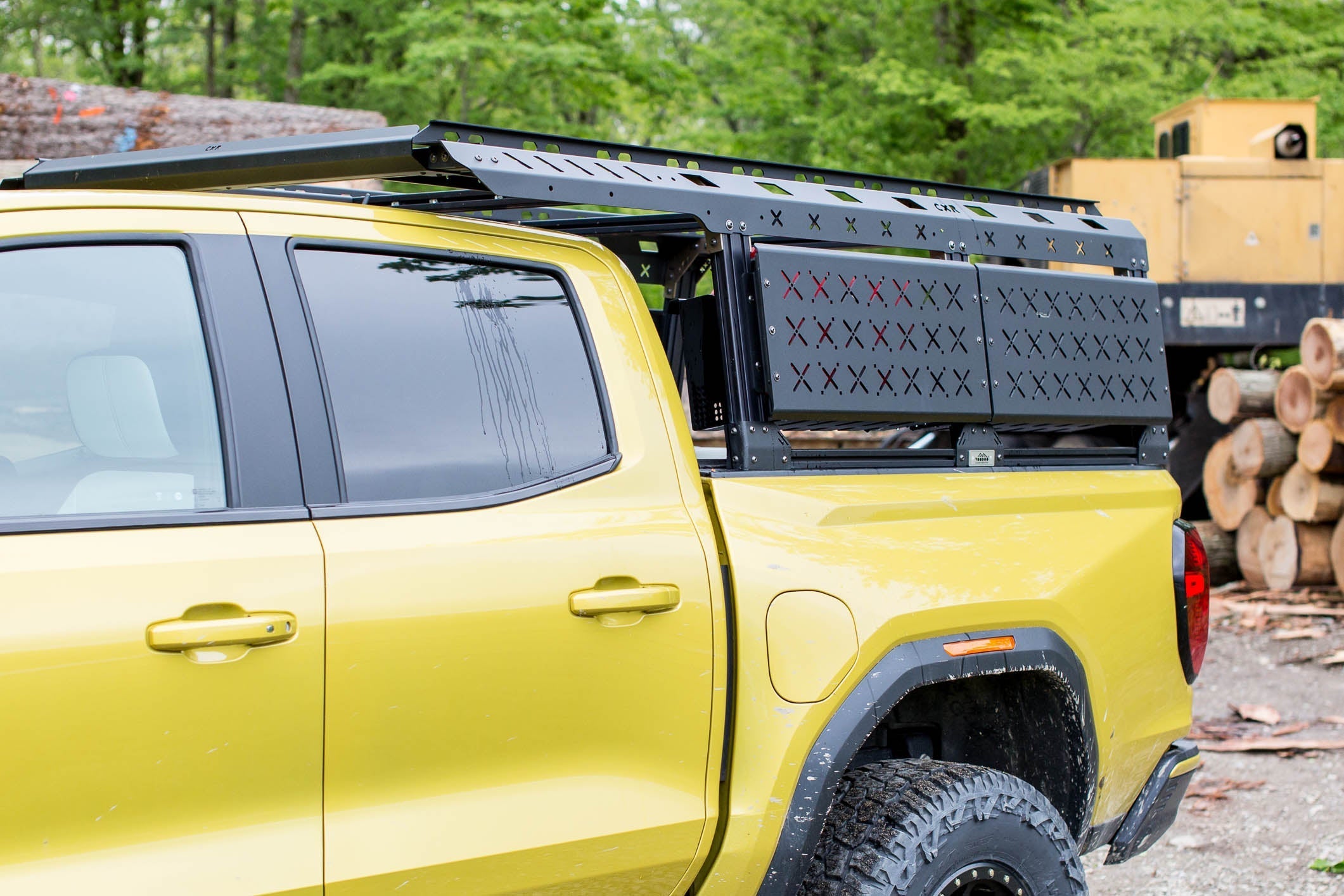 KB Voodoo CXR Utility Max bed rack with over-cab extension on yellow GMC Canyon AT4X at lumber yard