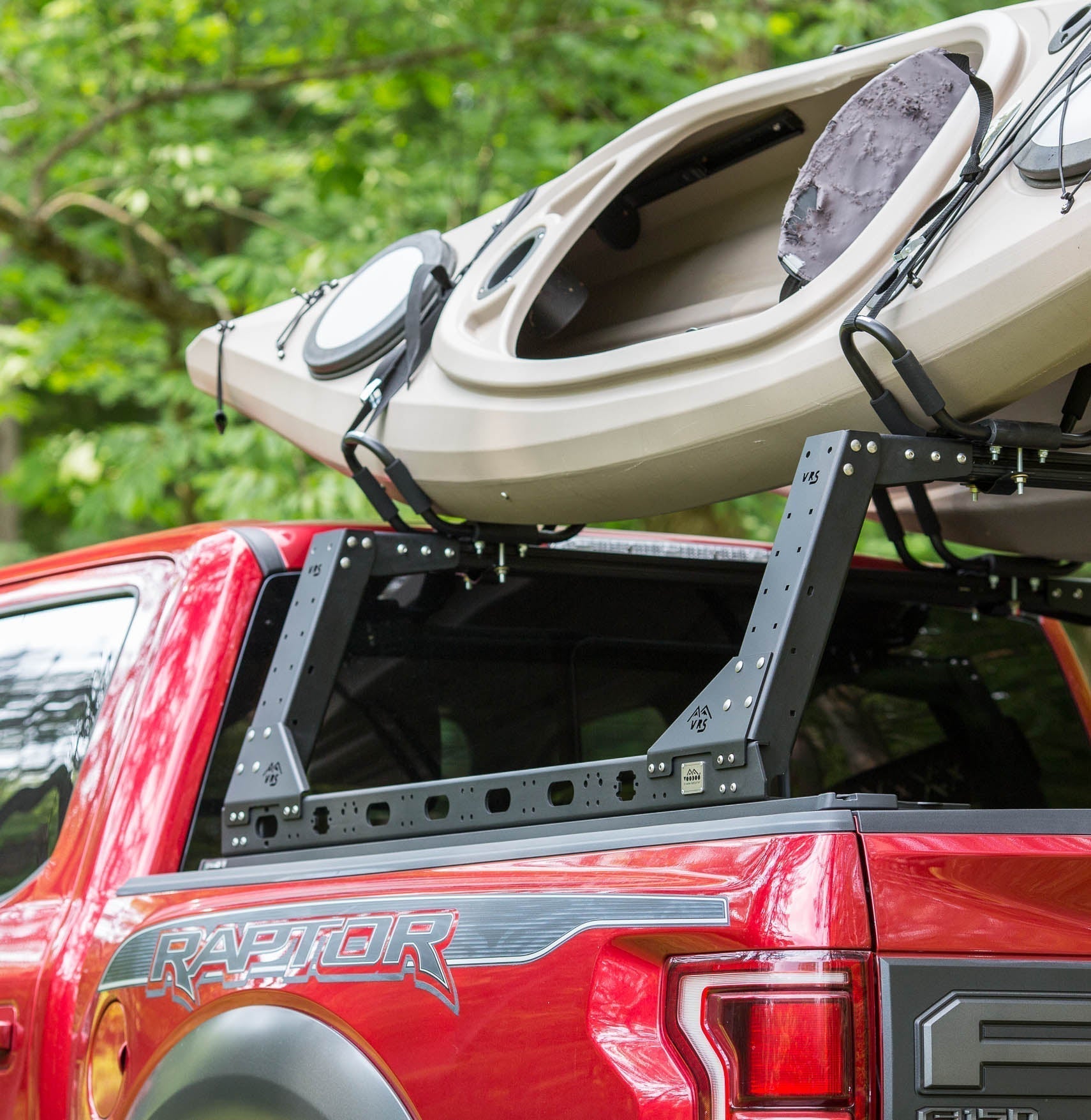 KB Voodoo VRS kayak rack with kayak loaded on red Ford F-150 Raptor truck bed