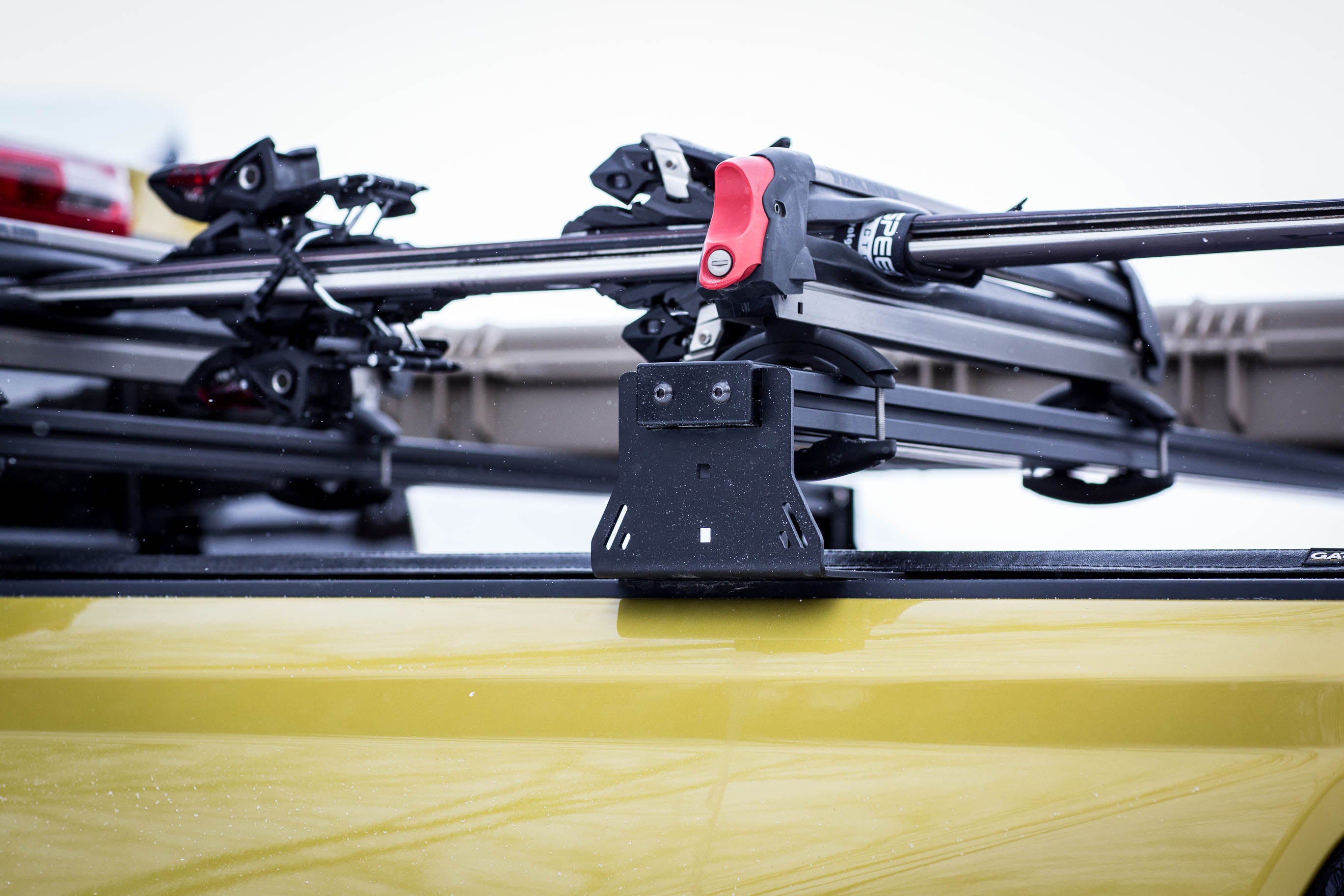 Roof rack system on a yellow vehicle with a blurred background