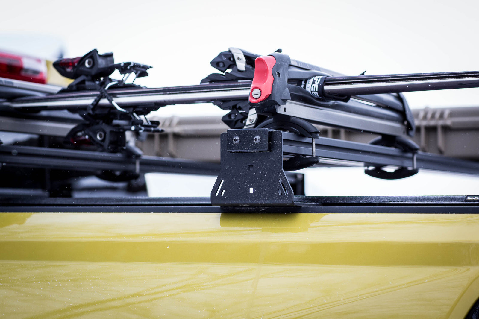 Roof rack system on a yellow vehicle with a blurred background