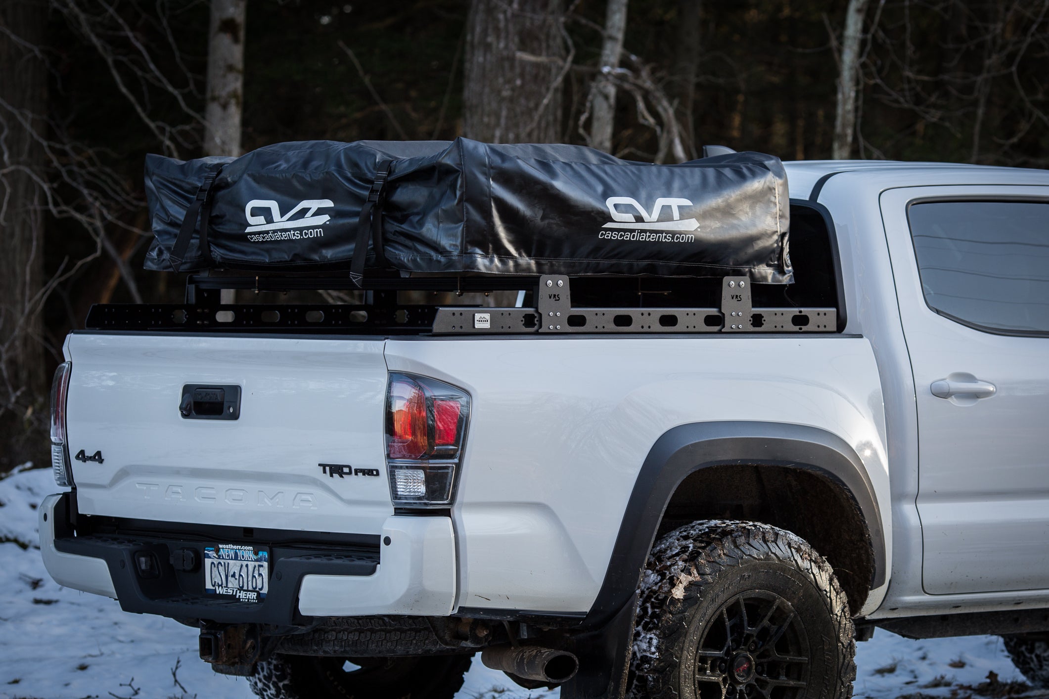 low profile truck bed crossbars on Toyota Tacoma with rooftop tent
